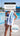 Just Keep Swimming beach towel over a triathlete's shoulder poolside — tough swim towel for daily brick workouts