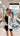 Triathlete in swim cap with Just Keep Swimming towel in the locker room — race-day ready swim training towel