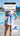 Just Keep Swimming towel with freestyle swimmer graphic held poolside — durable towel for early pool sessions and race days