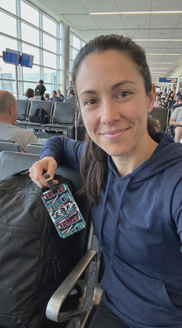 15-second video: triathlete at an airport gate shows the Triathlon Is a Mental Sport acrylic tag on her transition bag